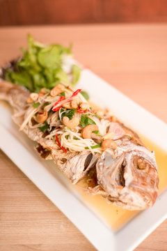 Thai food fried fish with mango salad