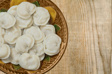 Boiled dumplings on the plate on the table.