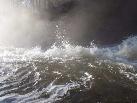 Steam at the bottom of a waterfall