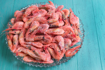 Large glass dish with a large frozen shrimp