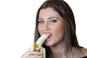 Cute brunette lady wear black shirt, holding and eating a peeled banana