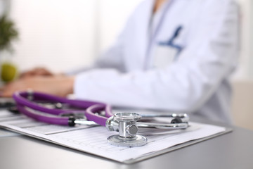 Portrait of happy medical doctor woman in office