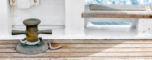 Details of vintage sailboat wooden deck and brass hardware 