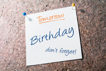 Birthday Reminder For Tomorrow On Paper Pinned On Cork Board