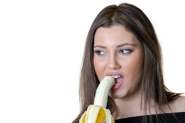 Cute brunette lady wear black shirt, holding and eating a peeled banana