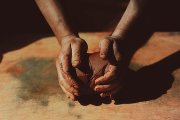 Close up of man's hand holding pottery clay