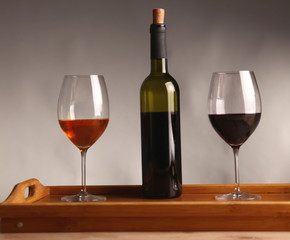 wine bottle and wine glass on a glass table