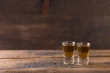 whiskey in glass on wood background