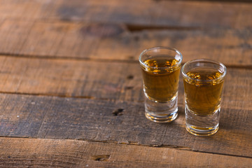 whiskey in glass on wood background