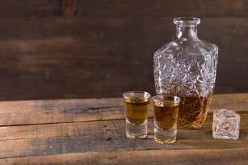 Obraz na płótnie Canvas whiskey in glass on wood background