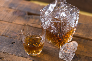 whiskey in glass on wood background