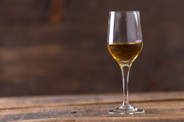 whiskey in glass on wood background