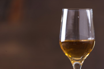 whiskey in glass on wood background