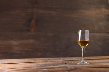 whiskey in glass on wood background