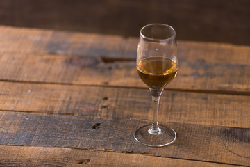whiskey in glass on wood background