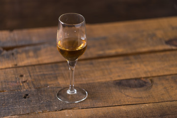 whiskey in glass on wood background