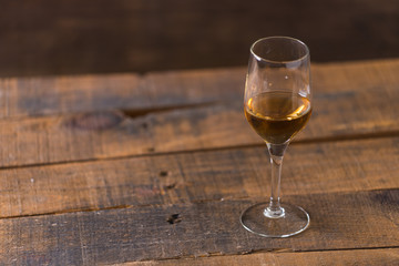 whiskey in glass on wood background