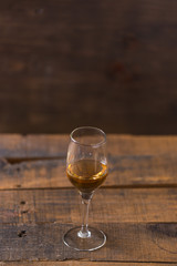 whiskey in glass on wood background