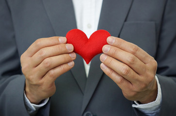 Businessman holding a red heart - crm - service mind