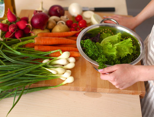 Young Woman Cooking in the kitchen. Healthy Food
