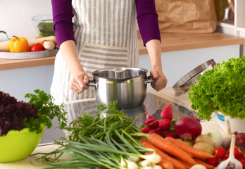 Young Woman Cooking in the kitchen. Healthy Food