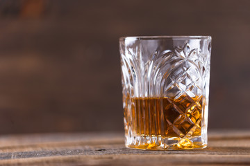 whiskey in glass on wood background