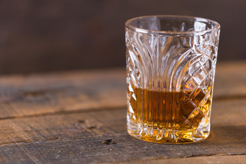 whiskey in glass on wood background