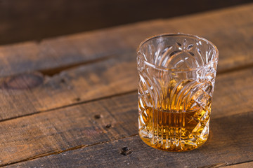 whiskey in glass on wood background