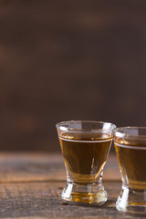 whiskey in glass on wood background