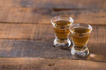 whiskey in glass on wood background