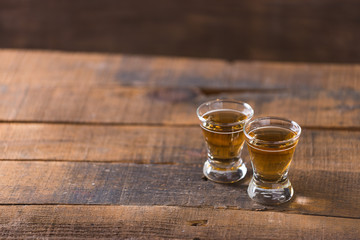 whiskey in glass on wood background