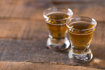 whiskey in glass on wood background