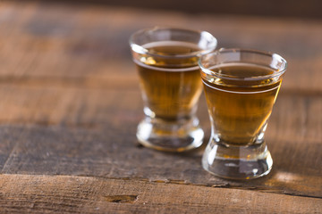 whiskey in glass on wood background