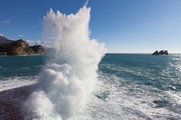 Stone breakwater with breaking waves.