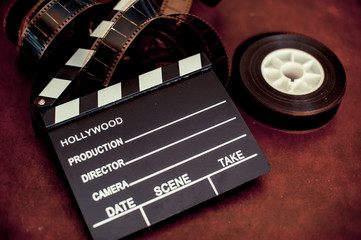 Movie clapper board and filmstrip selective focus