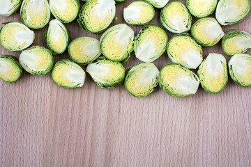 Cut  brussels sprout lay flat on wooden board