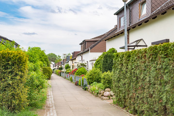 Architectural duplex houses with hedges and flowers in Germany