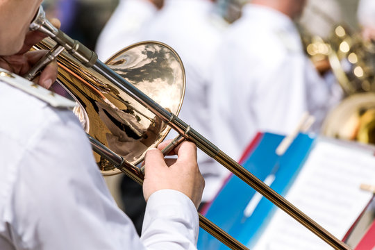 musician playing the trombone in the military orchestra