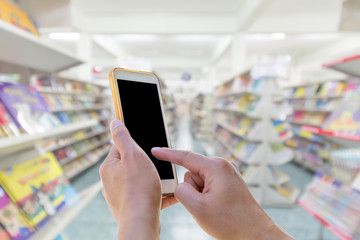 Man using touch screen mobile phone with blurred background in B