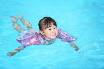 Happy little girl in the pool