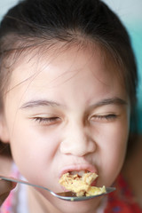 Little asian girl eating food