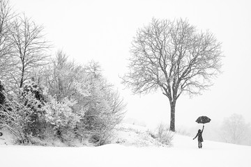 Lonely  woman walking in snow storm