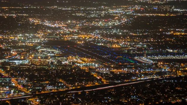 Night airport cityscape time lapse in Burbank and Los Angeles, California.