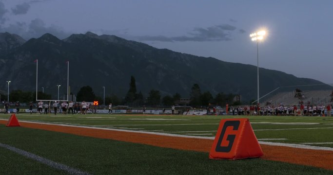 A shot of the goal line as high school football players play in the distance.