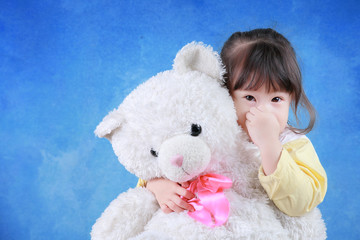 Portrait of little girl with teddy bear