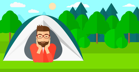 Man lying in tent.