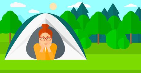 Woman lying in tent.