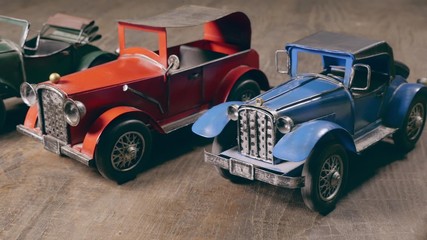 Retro metal toy car over wooden table. Retro style. Dolly shot.