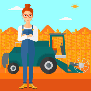Woman standing with combine on background.
