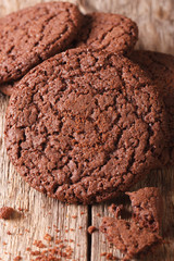 Fresh chocolate cookies with cracks macro on the table. vertical top view 
